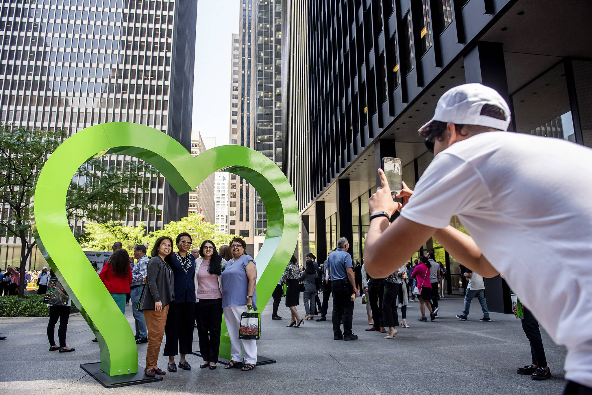 A giant green heart arch has popped up in Toronto's financial district thanks to the #TDReunited festival