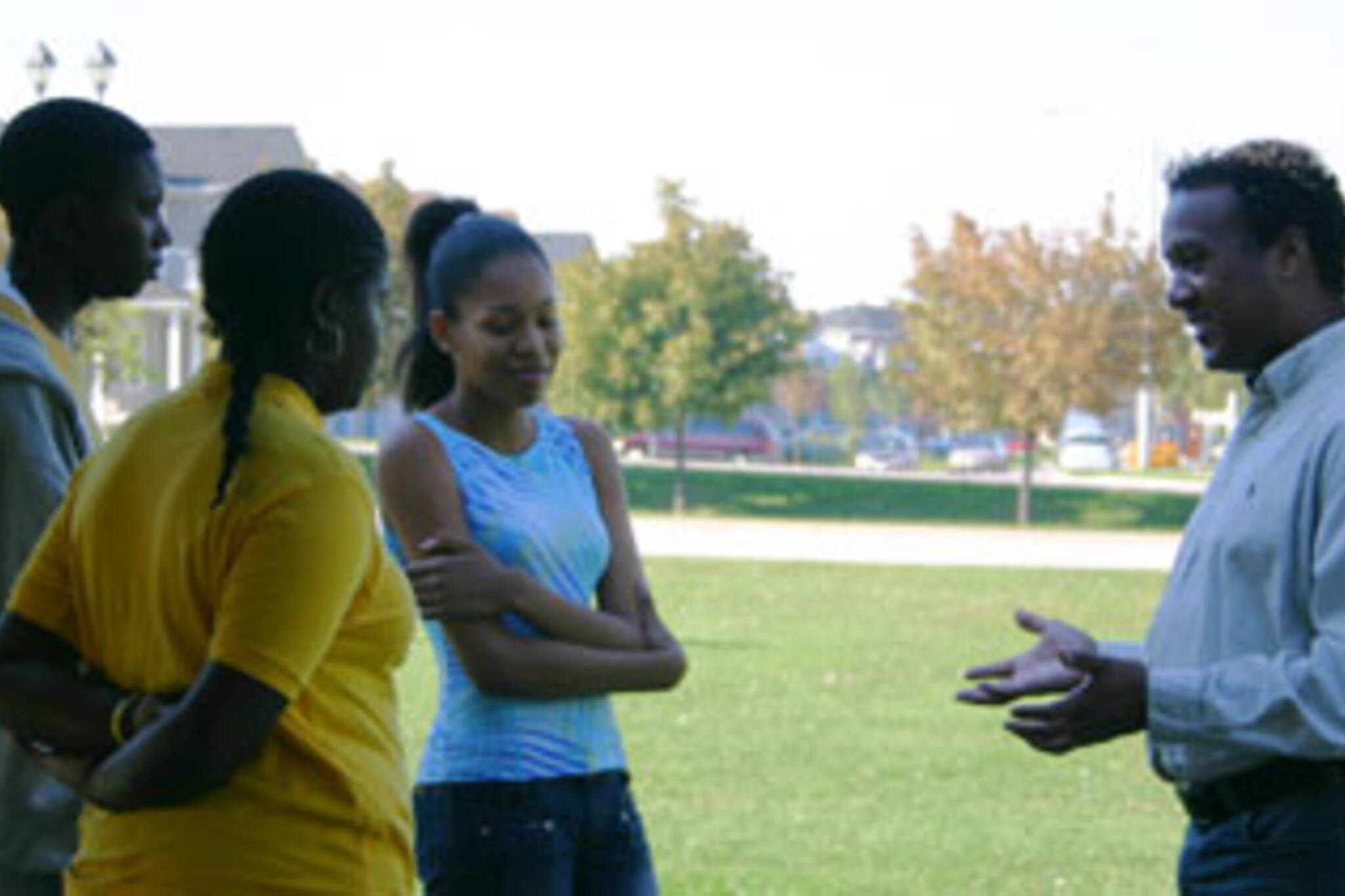 Donald Blair (right) talks to a group of youth at his kick-off barbecue