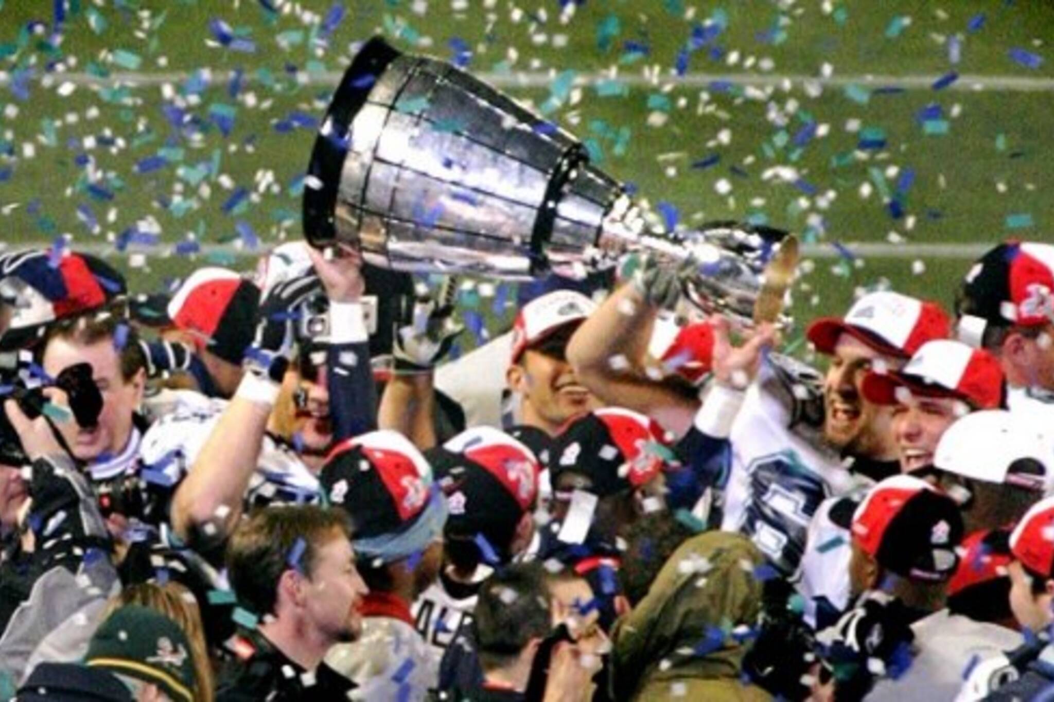 Argos celebrate Grey Cup victory in 2004 under coach Pinball Clemons, hired by J.I. Albrecht
